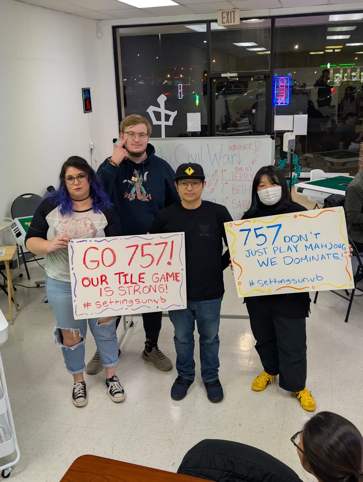 Friends laughing and socializing around a mahjong table at Setting Sun Virginia Beach